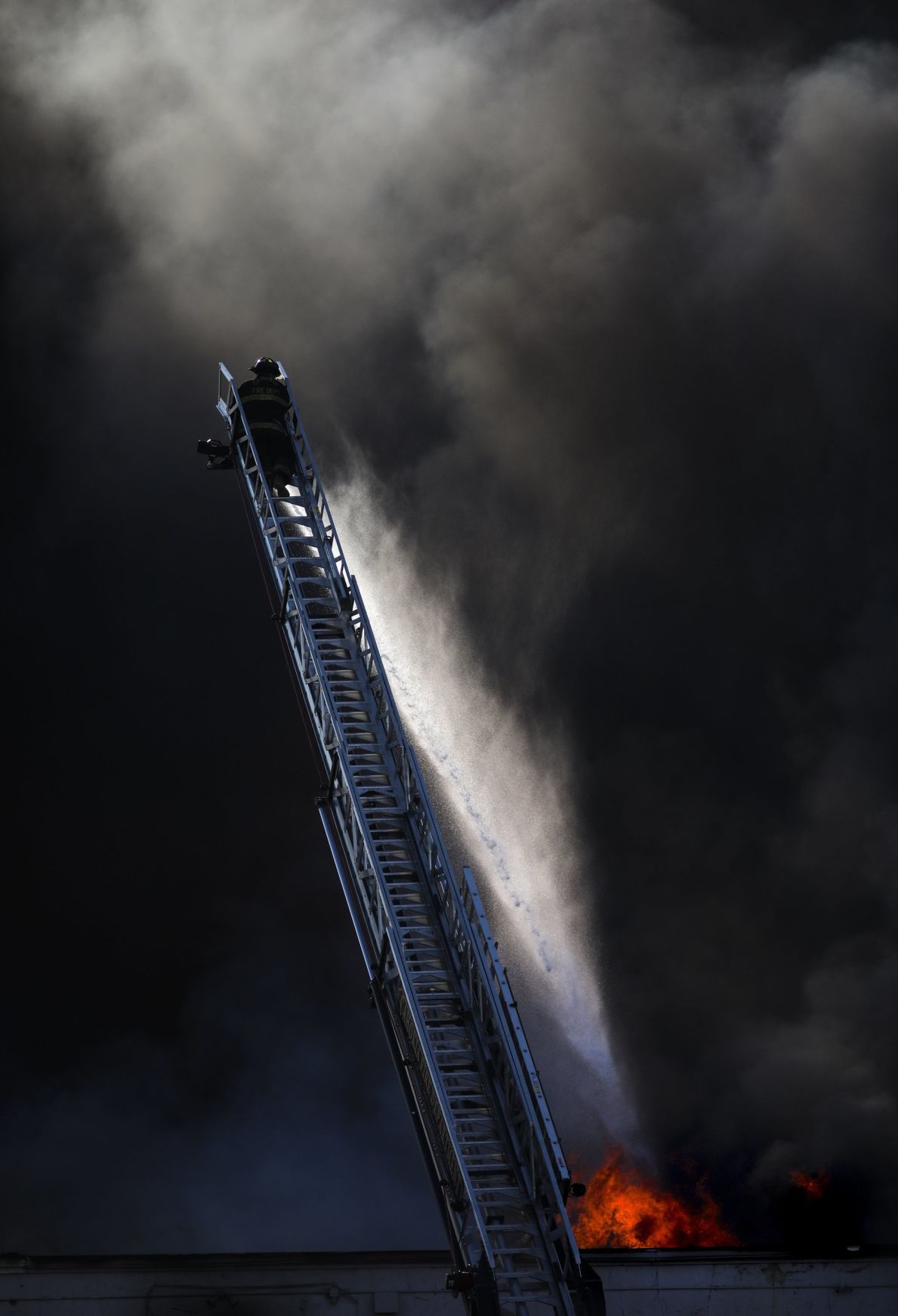 Large fire rolls through warehouse
